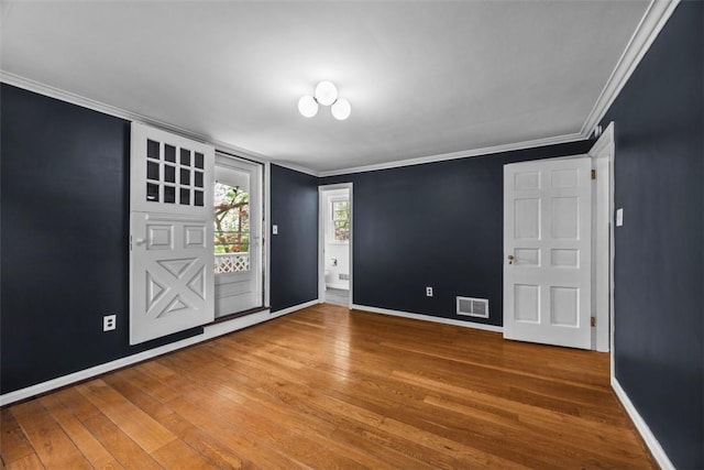 1509 Walnut St, Edgewood, PA 15218 - spare room featuring wood finished floors, ornamental molding, and baseboards