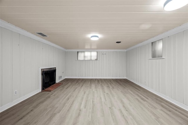 1509 Walnut St, Edgewood, PA 15218 - basement with wood finished floors, crown molding, a brick fireplace, and baseboards