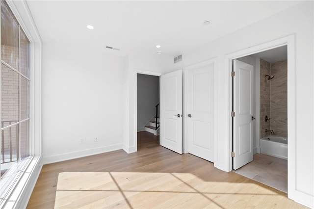 244 44th St, Lawrenceville, PA 15201 - unfurnished bedroom with wood finished floors, baseboards, recessed lighting, and ensuite bathroom