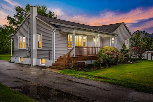 4624 Clear Shade Dr, Windber, PA 15963 - ranch-style house with covered porch, a chimney, a lawn, and roof with shingles