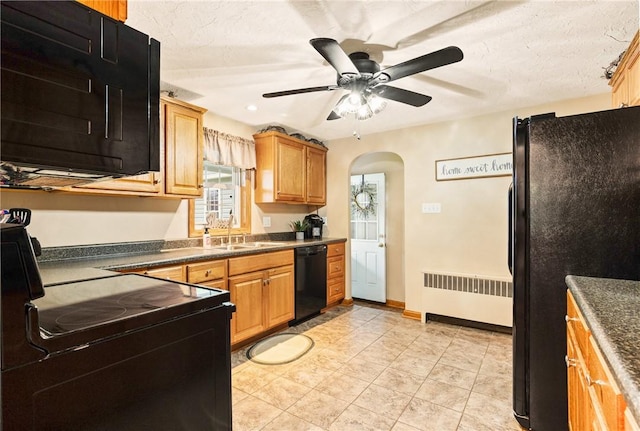 4624 Clear Shade Dr, Windber, PA 15963 - kitchen featuring radiator, black appliances, a sink, arched walkways, and dark countertops