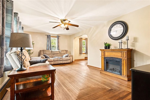 4624 Clear Shade Dr, Windber, PA 15963 - living area with a premium fireplace, ceiling fan, arched walkways, and baseboards