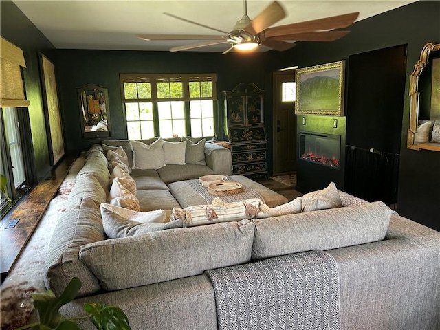 1050 Overlook Dr N, Franklin Twp, PA 15301 - living area with ceiling fan, a glass covered fireplace, and wood finished floors