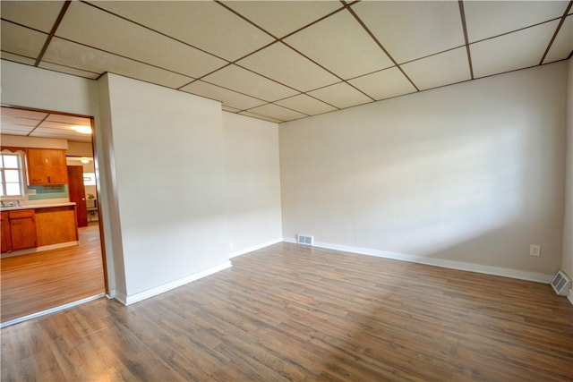 61/63 Orchard, Mckees Rocks, PA 15136 - unfurnished room featuring wood finished floors, baseboards, and a drop ceiling