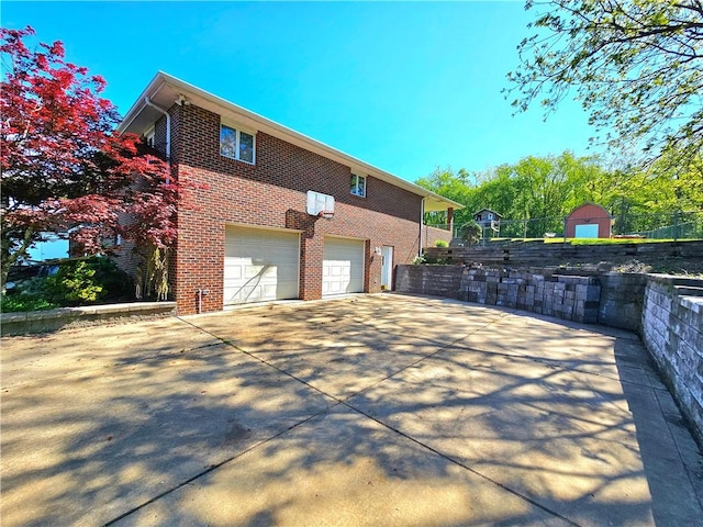 2977 Clay Pike, Sewickley Twp, PA 15678 - view of side of property with an attached garage, brick siding, and driveway