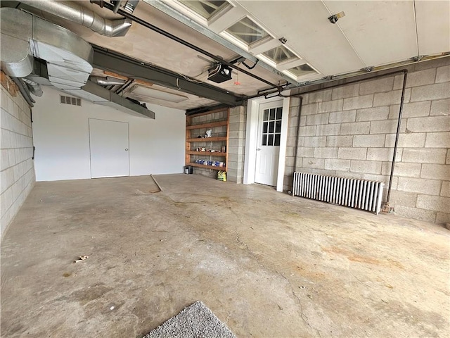2977 Clay Pike, Sewickley Twp, PA 15678 - garage featuring a garage door opener and concrete block wall