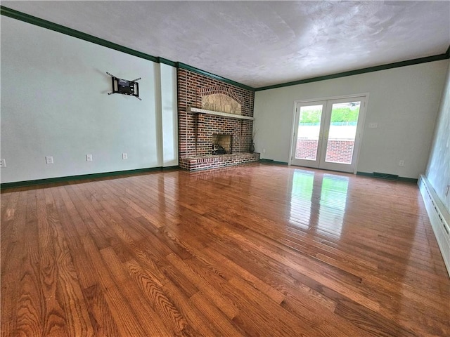 2977 Clay Pike, Sewickley Twp, PA 15678 - unfurnished living room featuring wood finished floors, ornamental molding, baseboards, a fireplace, and baseboard heating