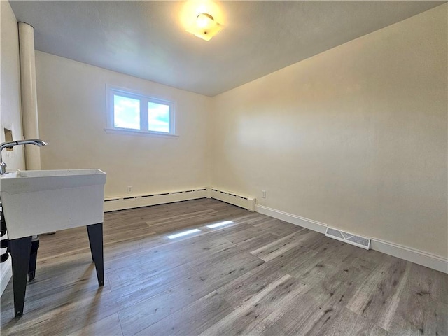 2977 Clay Pike, Sewickley Twp, PA 15678 - interior space featuring wood finished floors, baseboards, and a baseboard radiator