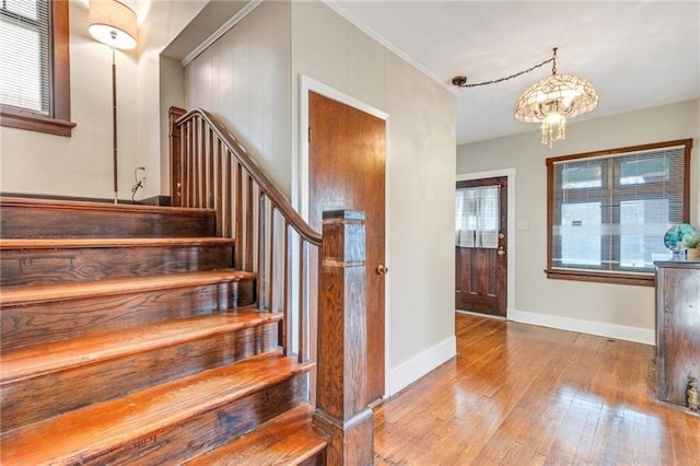 901 Ross Ave, Wilkinsburg, PA 15221 - stairway with hardwood / wood-style floors, a chandelier, and baseboards