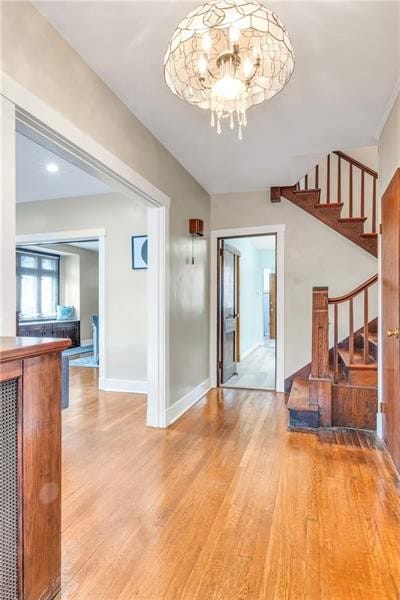 901 Ross Ave, Wilkinsburg, PA 15221 - entryway featuring light wood-style floors, stairway, a chandelier, and baseboards