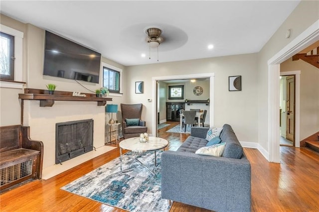 901 Ross Ave, Wilkinsburg, PA 15221 - living room featuring wood finished floors, a fireplace with flush hearth, ceiling fan, healthy amount of natural light, and recessed lighting
