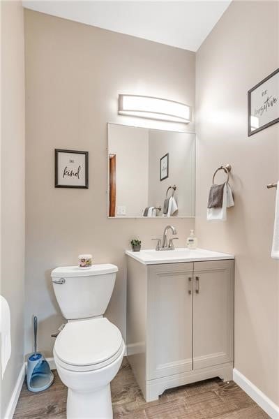 901 Ross Ave, Wilkinsburg, PA 15221 - bathroom featuring vanity, toilet, baseboards, and wood finished floors