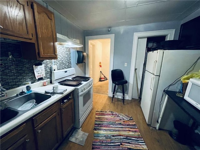 471 Lincoln Ave, Bellevue, PA 15202 - kitchen with white appliances, extractor fan, a sink, tasteful backsplash, and wood finished floors