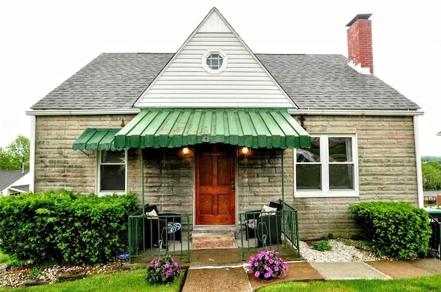 1025 Nevada St, South Strabane, PA 15301 - view of front facade featuring a shingled roof, a chimney, and stone siding