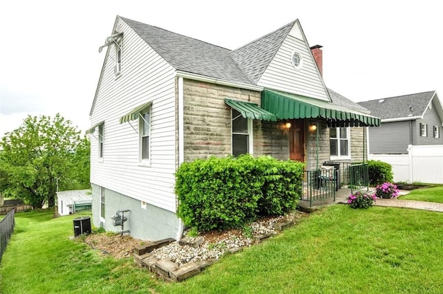 1025 Nevada St, South Strabane, PA 15301 - view of front of house featuring a shingled roof, a chimney, and stone siding