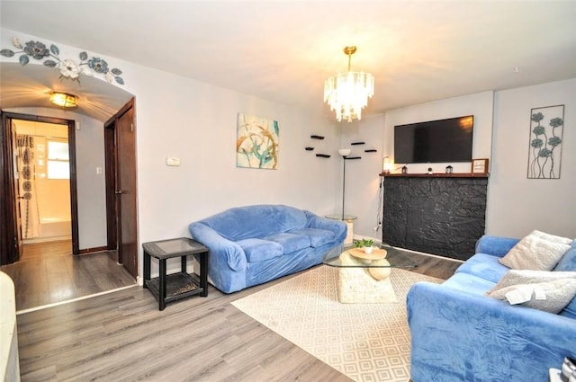 1025 Nevada St, South Strabane, PA 15301 - living area featuring wood finished floors, a chandelier, and baseboards