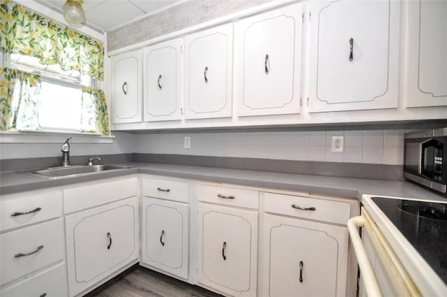 1025 Nevada St, South Strabane, PA 15301 - kitchen featuring a sink, stainless steel microwave, and white cabinetry