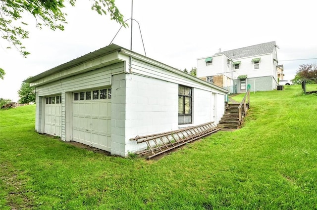1025 Nevada St, South Strabane, PA 15301 - view of side of home with stairs, a detached garage, a yard, and an outdoor structure