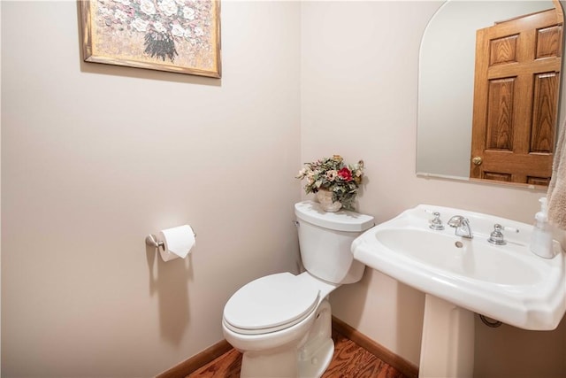 240 Lindsay Rd, Jackson Twp But, PA 16063 - half bath featuring toilet, baseboards, wood finished floors, and a sink