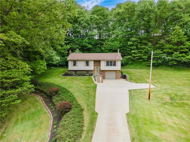 240 Lindsay Rd, Jackson Twp But, PA 16063 - split foyer home with driveway, a chimney, an attached garage, a front yard, and brick siding