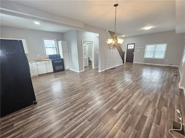 418 Short St, Donora, PA 15033 - unfurnished dining area with dark wood-style flooring, stairs, recessed lighting, and a chandelier