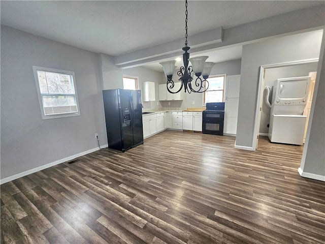 418 Short St, Donora, PA 15033 - kitchen with black refrigerator with ice dispenser, estacked washer and dryer, a chandelier, range, and white cabinets