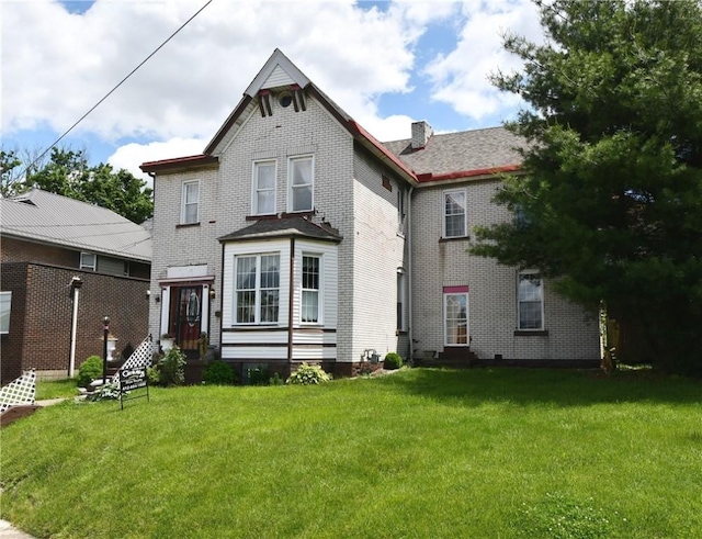 108 Locust St, Mount Oliver, PA 15210 - view of front of property with a front yard, brick siding, and a chimney