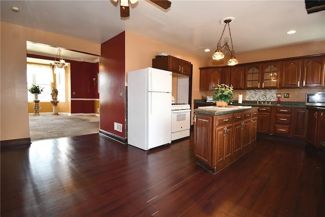 108 Locust St, Mount Oliver, PA 15210 - kitchen with white appliances, dark countertops, a sink, ceiling fan, and a center island