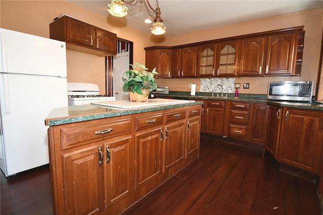 108 Locust St, Mount Oliver, PA 15210 - kitchen featuring white appliances, dark wood finished floors, a center island, glass insert cabinets, and decorative light fixtures