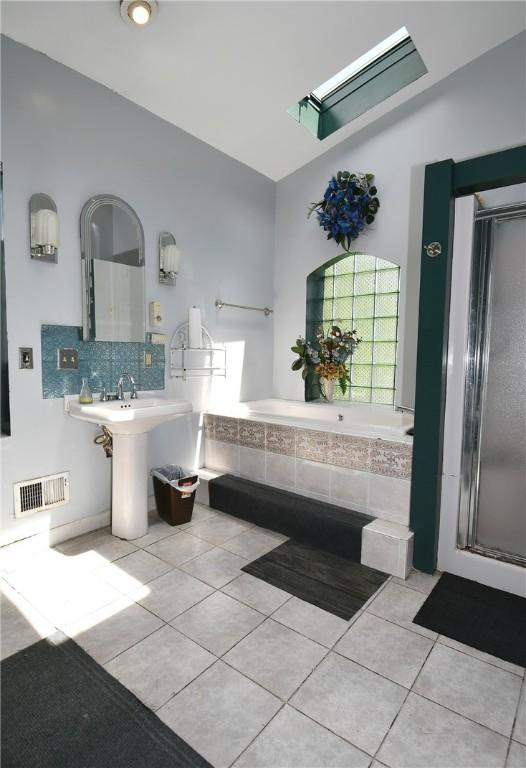 108 Locust St, Mount Oliver, PA 15210 - bathroom with tile patterned flooring, a garden tub, tasteful backsplash, and a shower with door