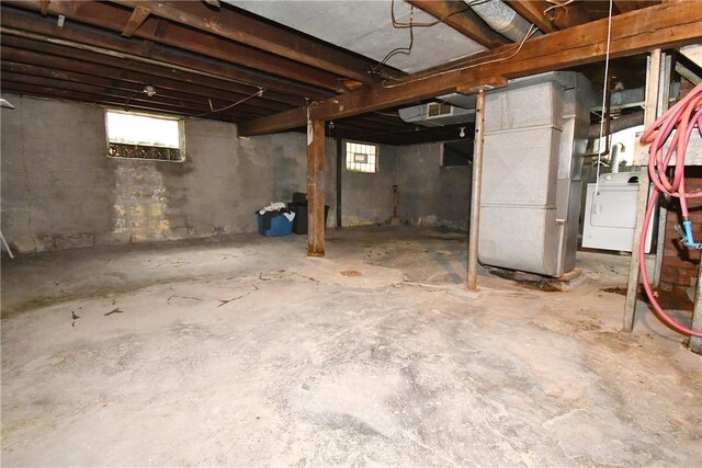 108 Locust St, Mount Oliver, PA 15210 - basement featuring heating unit, healthy amount of natural light, and washer / clothes dryer