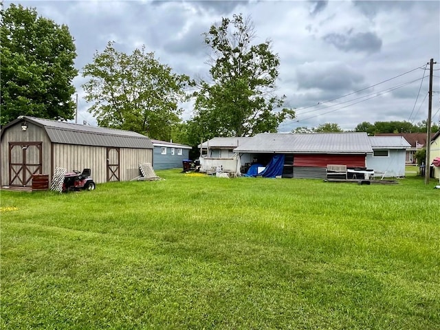 10672 Center Ave, Conneaut Lake, PA 16316 - view of grassy yard featuring a storage unit