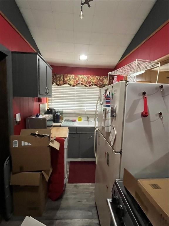 10672 Center Ave, Conneaut Lake, PA 16316 - kitchen featuring freestanding refrigerator, electric stove, wood finished floors, and lofted ceiling