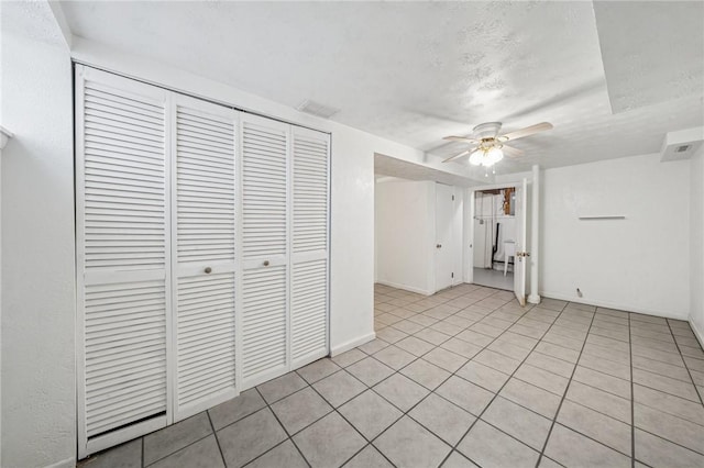 134 Hamilton Dr, Penn Hills, PA 15235 - unfurnished living room with a ceiling fan, baseboards, light tile patterned floors, and a textured ceiling