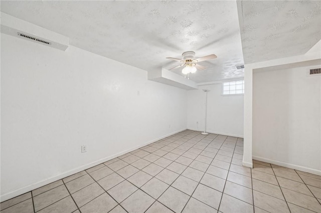 134 Hamilton Dr, Penn Hills, PA 15235 - spare room featuring a ceiling fan, a textured ceiling, baseboards, and light tile patterned floors
