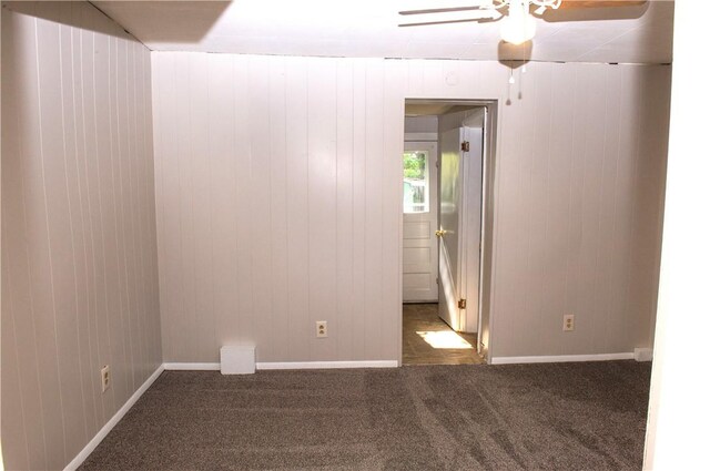 120 N 6th Ave, City Of But Nw, PA 16001 - carpeted empty room with a ceiling fan, wood walls, and baseboards