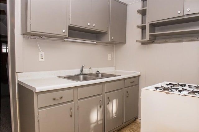 120 N 6th Ave, City Of But Nw, PA 16001 - kitchen featuring open shelves, a sink, gray cabinetry, and gas range gas stove