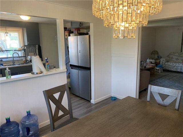3003 Jersey St, Mckeesport, PA 15132 - kitchen with a sink, a chandelier, wood finished floors, and baseboards