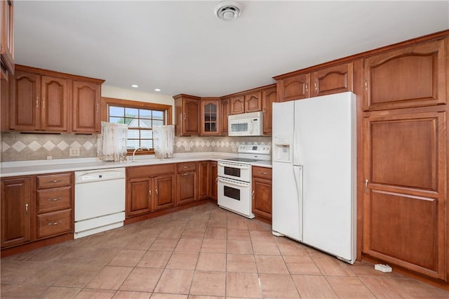 306 N Rd, Franklin Twp But, PA 16001 - kitchen featuring white appliances, brown cabinetry, a sink, decorative backsplash, and recessed lighting