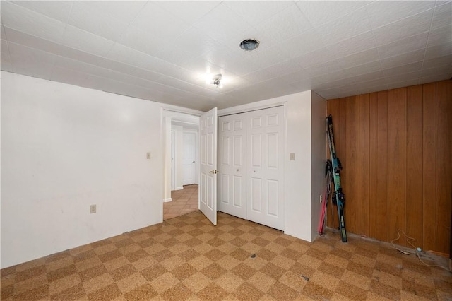 306 N Rd, Franklin Twp But, PA 16001 - unfurnished bedroom featuring wooden walls, a closet, and light colored carpet