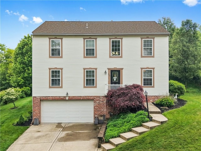205 Emily Dr, Cranberry Twp, PA 16066 - colonial home featuring a garage, brick siding, driveway, and a front yard