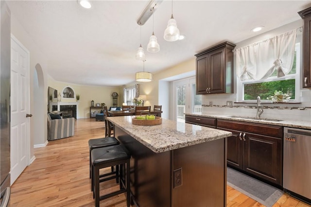 205 Emily Dr, Cranberry Twp, PA 16066 - kitchen with stainless steel dishwasher, a sink, a center island, dark brown cabinetry, and light wood finished floors
