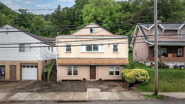4072 Jordan St, South Heights, PA 15081 - view of front of property featuring stairs, a garage, asphalt driveway, and brick siding
