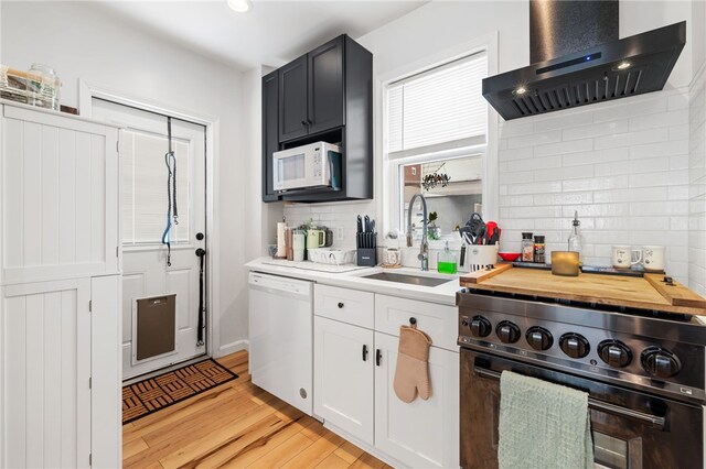 62 Laurel Ave, City Of Washington, PA 15301 - kitchen featuring wall chimney range hood, white appliances, a sink, tasteful backsplash, and light wood-type flooring