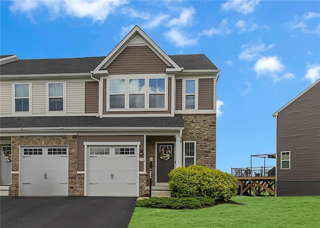 2054 Cade Dr, Potter Twp, PA 15061 - view of front of house with stone siding, driveway, a garage, a front lawn, and a shingled roof