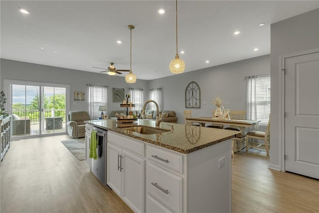 2054 Cade Dr, Potter Twp, PA 15061 - kitchen with a sink, dishwasher, open floor plan, light wood-type flooring, and dark stone counters