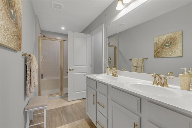 2054 Cade Dr, Potter Twp, PA 15061 - full bath with wood finished floors, double vanity, a stall shower, and recessed lighting