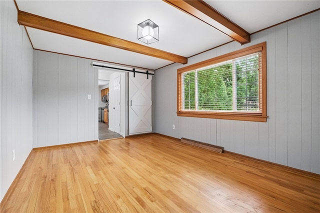7965 Remington Dr, Mccandless, PA 15237 - unfurnished bedroom featuring beam ceiling, light wood finished floors, a barn door, and wooden walls