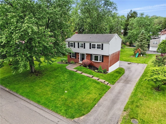 7965 Remington Dr, Mccandless, PA 15237 - colonial house featuring brick siding, asphalt driveway, a front yard, and a shingled roof