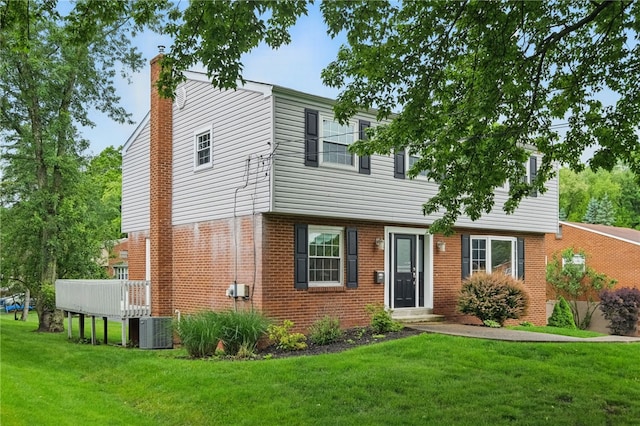 7965 Remington Dr, Mccandless, PA 15237 - colonial home featuring a chimney, a front yard, central AC unit, and brick siding